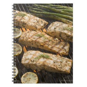 Fish and asparagus cooking on grill notebook