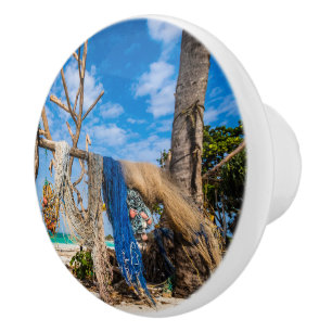 Fishing nets drying on the beach ceramic knob