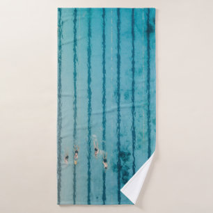 Five people swimming on pool bath towel