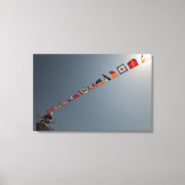 Flags fly over the deck of the USS Iwo Jima Canvas Print (Front)