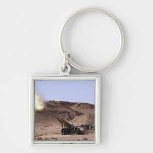 Flame and smoke emerge from the muzzle key ring