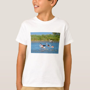 Flamingos running on water in Camargue T-Shirt