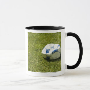 Flat soccer ball in grass, Germany Mug