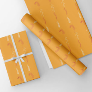 Floral doodles on golden orange wrapping paper sheet
