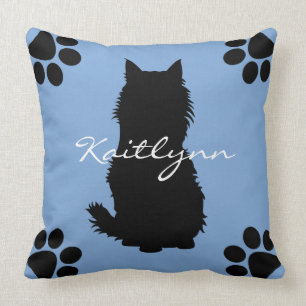 Fluffy Black Cat and paws on Blue Cushion