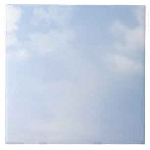 Fluffy clouds on pastel blue sky tile