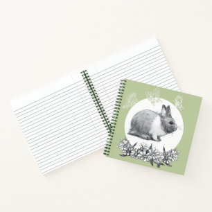 Fluffy hare with butterflies on green background notebook