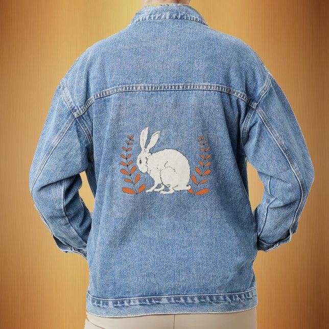 Fluffy Sitting White Bunny Orange Plants Denim Jacket (Sitting white bunny with tall leafy orange plants on a denim jean jacket.)