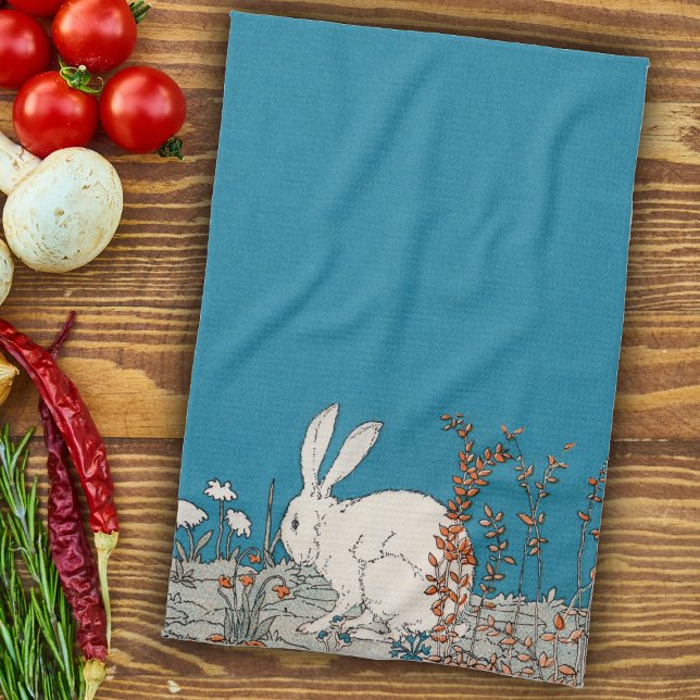 Fluffy White Bunny Sitting in Flowers on Dark Blue Tea Towel (White rabbit sitting on ground in orange and white flowers medium blue kitchen hand towel.)