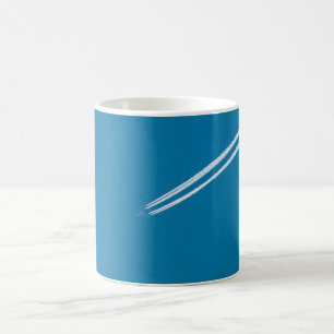 Flying aeroplane on a blue sky background coffee mug