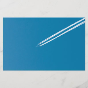 Flying aeroplane on a blue sky background flyer
