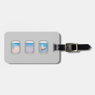 flying pig through aeroplane window luggage tag