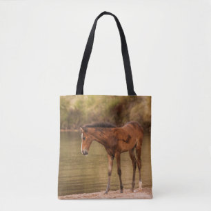 Foal at the river tote bag