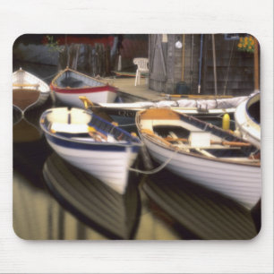 Fog surrounds four boats docked. mouse mat