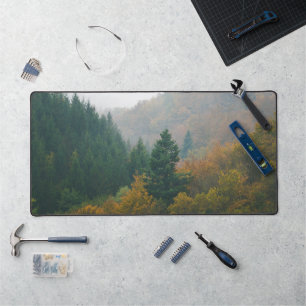 Foggy autumn forest layers disappearing in fog desk mat