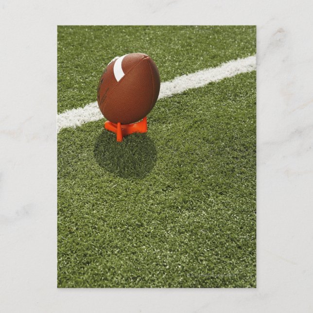 Football atop tee on football field, elevated postcard (Front)