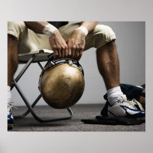 Football player sitting in locker room poster