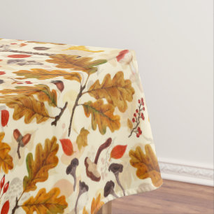 Forest mushrooms and autumn flora on cream tablecloth