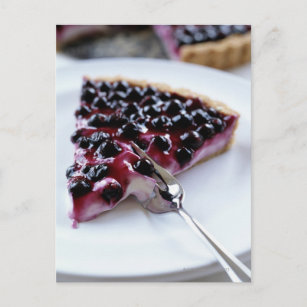 Fork slicing blueberry pie on plate postcard
