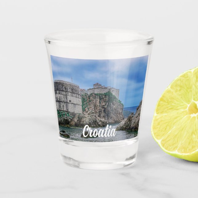 Fortress walls, rocky coast and sea in Croatia Shot Glass (Front)