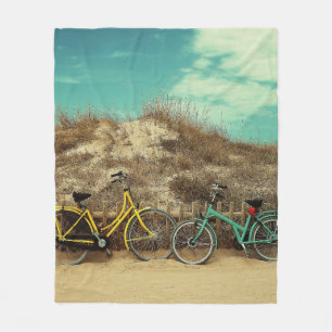Four assorted-colour commuter bikes near hill at d fleece blanket