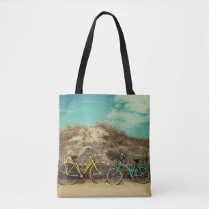 Four assorted-colour commuter bikes near hill at d tote bag