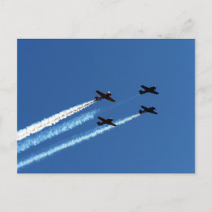 four flying planes with trails blue sky postcard