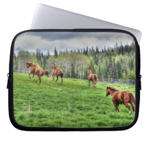 Four Horses Running on Fresh Grass in a Paddock Laptop Sleeve