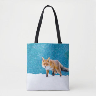 Fox in winter. Red fox, Vulpes vulpes, sniffs abou Tote Bag