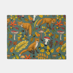Foxes and buttercups on black doormat