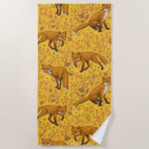 Foxes and buttercups on orange beach towel