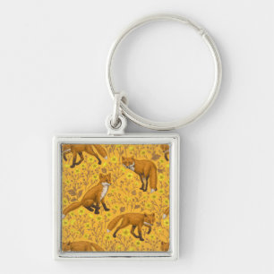 Foxes and buttercups on orange key ring