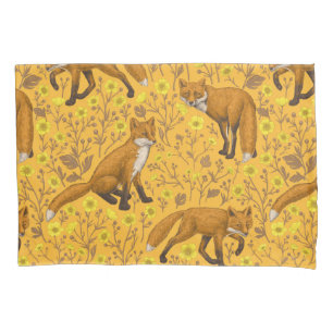 Foxes and buttercups on orange pillowcase