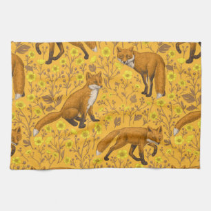 Foxes and buttercups on orange tea towel