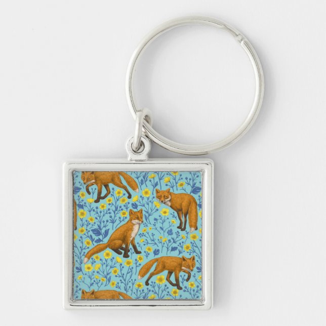 Foxes and buttercups on pool blue key ring (Front)