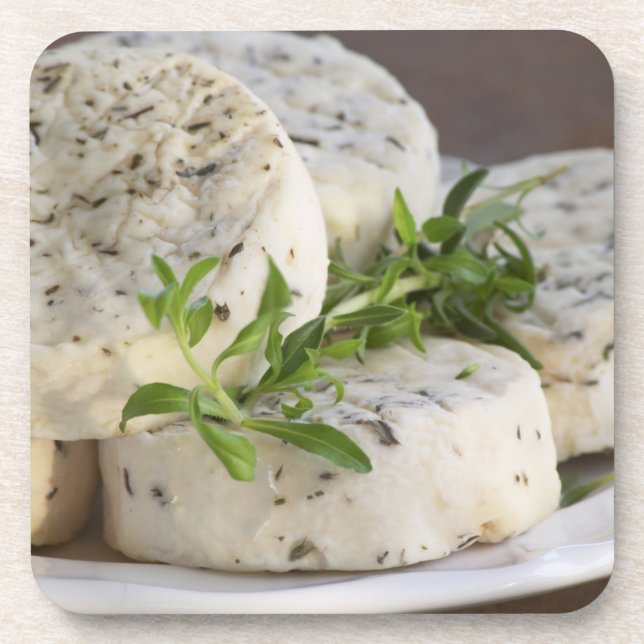 French goat cheese - chevre - with herbs on a coaster (Front)