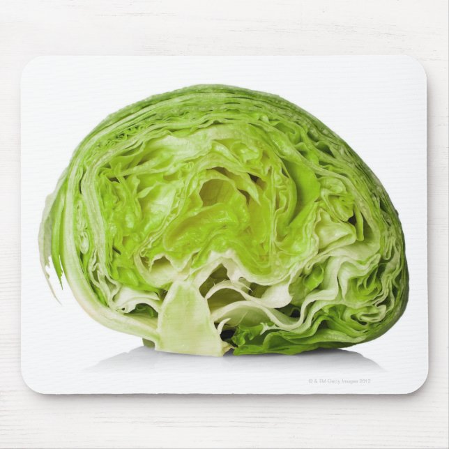 Fresh iceberg lettuce cut in half, on white mouse mat (Front)
