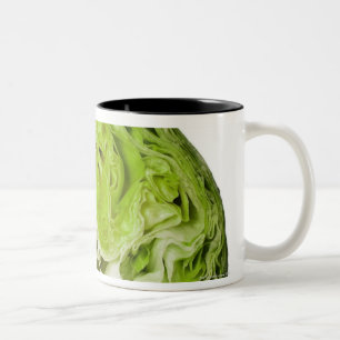 Fresh iceberg lettuce cut in half, on white Two-Tone coffee mug