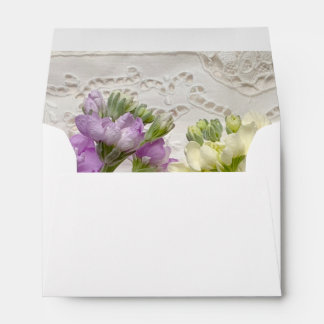 Fresh lilacs on old lace envelope