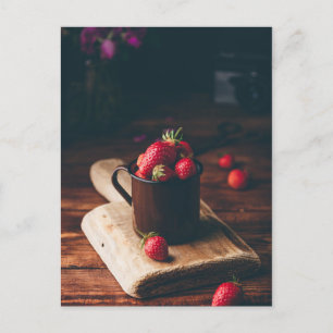 Fresh red strawberries in metal mug on table. postcard