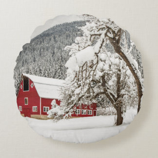 Fresh snow on red barn round cushion