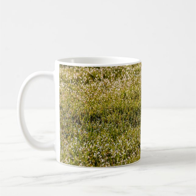 Fresh spring green grass background, with bokeh ef coffee mug (Left)