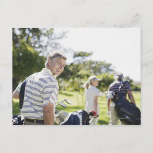 Friends carrying golf bags postcard