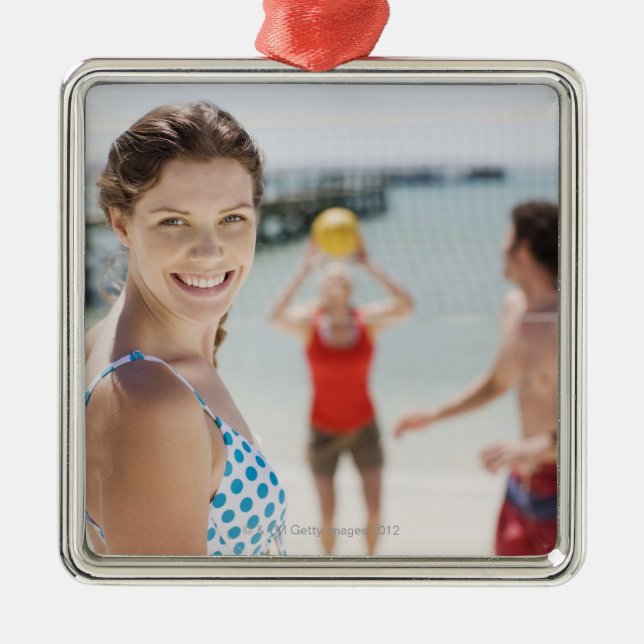 Friends playing volleyball at beach metal tree decoration (Front)