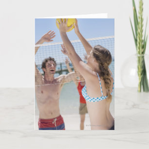 Friends playing volleyball on beach card