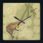Frog and Dragonfly on Water Lilies Square Wall Clock<br><div class="desc">This contemporary fine art print of a frog and a dragonfly on water lilies will brighten any product you choose. Get it on your favourite Zazzle product today!</div>