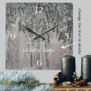 Frosted branches and a snow-covered forest square wall clock