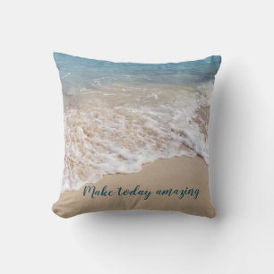 frothy sea foam on beach with quote cushion