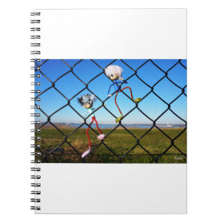 Fubby's climbing a fence. notebook