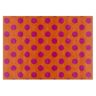 Fuchsia polka dots on orange cutting board